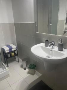 a white bathroom with a sink and a mirror at Al Borgo - Tenuta Borsari in Frascati +23 photos