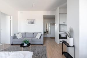 a living room with a couch and a table at "Pyynikinkulma" - 1BR Apt with Stunning Views, Sauna & Balcony in Tampere +20 photos