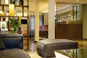 a living room with a couch and a chair at Hotel Du Nord in Interlaken