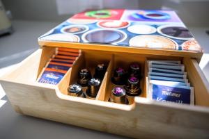 a wooden box filled with lots of different colored buttons at GREAT PLACE Top Penthouse Stuttgart Airport & Messe in Filderstadt