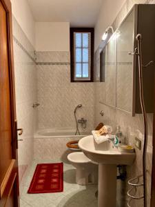 a bathroom with a toilet and a sink and a shower at Bergamo Central Living in Bergamo