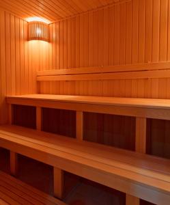 an empty sauna with wooden shelves and a light at Graf Orlov Hotel in Samara