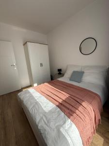 a bedroom with a large bed with a mirror on the wall at A63 by Real Apartment in Warsaw