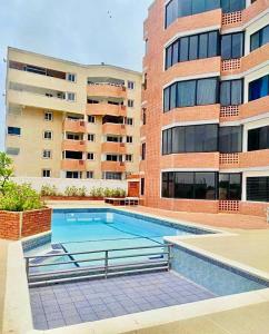 ein Schwimmbad vor einem Gebäude in der Unterkunft Comodidad y relax en Apartamento cerca del mar en Chichiriviche in Chichiriviche