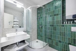 a bathroom with a sink and a shower and a toilet at Florin Apart Hotel in Budapest