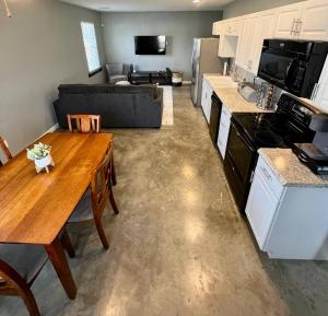 a kitchen and living room with a table and a couch at Posh Pad in Marion