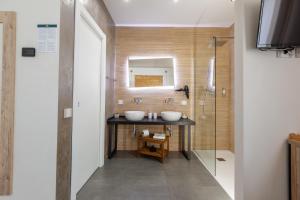 a bathroom with two sinks and a shower at Oneira Rooms in Agrigento +37 photos