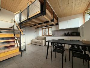 a kitchen and dining room with a table and chairs at Bed&Cheese Deggio in Quinto