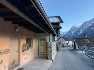 a building with a door on the side of a street at Bed&Cheese Deggio in Quinto