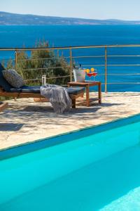 a swimming pool with a view of the ocean at Casa Malinas in Stanići