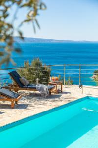 a swimming pool with a view of the ocean at Casa Malinas in Stanići