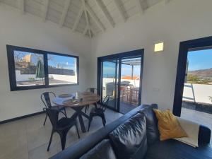 a living room with a blue couch and a table at Casa Camino Real in Los Barros
