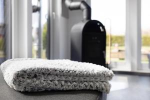 a white blanket sitting on a table next to a suitcase at Happy-Nest in Oberkrämer +20 photos
