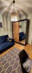 a living room with a mirror and a couch at Secret Room Niepołomice in Niepołomice