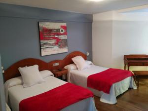 Postel nebo postele na pokoji v ubytování Hotel Urgaín