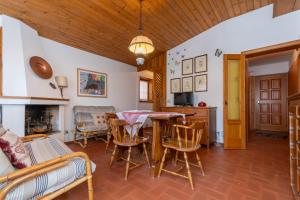 a living room with a table and chairs at Ciasa al Sol in Falcade