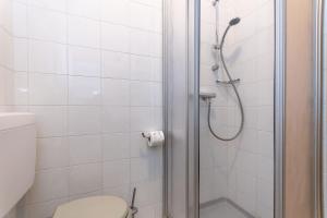 a bathroom with a shower with a toilet and a sink at Ciasa al Sol in Falcade