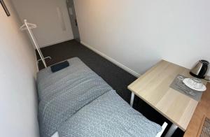 a room with a bed next to a table and a lamp at Fantastic-Inn Warszawa - Chmielna in Warsaw