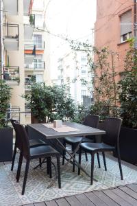 a black table and chairs on a patio at Happy Travelers Apartment by Holiday Solutions in Como