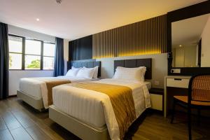 Postel nebo postele na pokoji v ubytování De Quinton Hotel + 37 fotografií