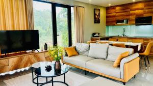 a living room with a couch and a tv at AN's House in Hòa Bình