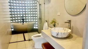 a bathroom with a tub and a sink and a toilet at AN's House in Hòa Bình +25 photos