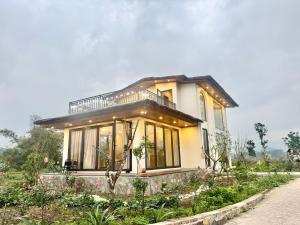 a small house with a lot of windows at AN's House in Hòa Bình