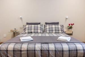 a bedroom with a bed with two towels on it at Casa Belfiore, Darfo Boario Terme Ospitar in Boario Terme