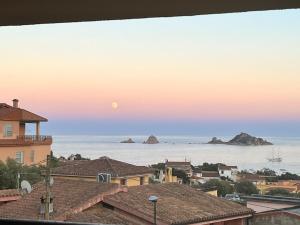 a view of the ocean from the roofs of houses at Casa Monni vista mare in Santa Maria Navarrese