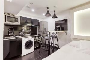 a kitchen with a washer and dryer in a room at Saint Michel in Paris