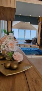 a table with a plate with flowers on it at Villa Melani **** in Oriovac