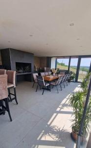 a patio with a table and chairs and a fireplace at Villa Melani **** in Oriovac