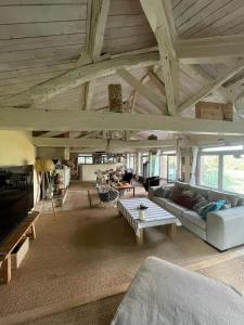 a living room with a couch and a table at Maison Atypique dans le Gers avec activités in Pavie