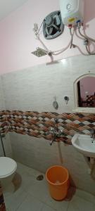 a bathroom with a toilet and a sink and a mirror at Room in Banjara Hills in Hyderabad