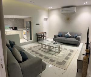 a living room with two couches and a table at Rfaa Suites in Medina