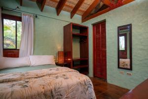 a bedroom with a bed in a room with windows at Casa Maya Lodge in Masatepe