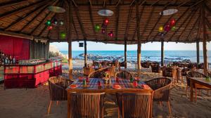 a restaurant on the beach with a table and chairs at The Park Visakhapatnam in Visakhapatnam