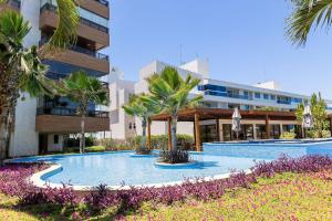 a swimming pool in front of a building at Paraíso do Atlântico #102D - Estilo por Carpediem in Ilha da Restinga