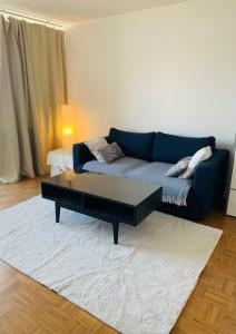 a living room with a couch and a coffee table at Business Messe Apartment & Wellness Spa in Düsseldorf
