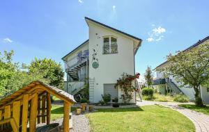 a house with a garden and a pathway at Apartment mit überdachter Terrasse 7 7 EG in Friedrichshafen