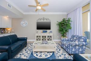 a living room with a couch and a tv at Phoenix Orange Beach II 603 condo in Orange Beach