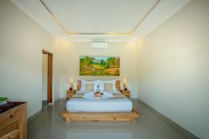 Postel nebo postele na pokoji v ubytování Villa Sri Rejeki + 13 fotografií