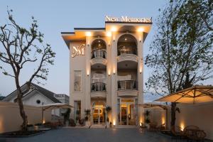 a large white building with a sign on it at New Memories Hotel DaLat in Xuan An