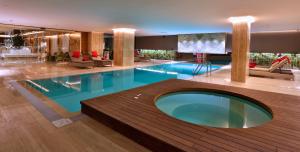 a large swimming pool in a hotel lobby at Dosso Dossi Hotels & SPA Downtown in Istanbul