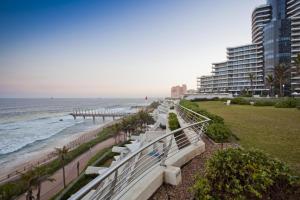 a view of the beach from the balcony of a resort at The Pearls of Umhlanga, or Oceans Apts in Durban