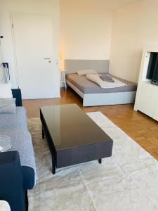 a living room with a bed and a coffee table at Business Messe Apartment & Wellness Spa in Düsseldorf