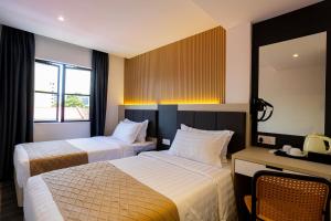 Postel nebo postele na pokoji v ubytování De Quinton Hotel