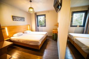 Postel nebo postele na pokoji v ubytování Temis hôtel Besançon