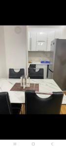 an empty room with a table and chairs and a table and chairsktop at Stan na dan Banja luka Mejdan in Hiseti +4 photos