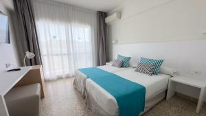 a hotel room with a bed and a window at BLUESEA Piscis - Adults Only in Port d'Alcudia +27 photos